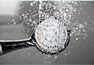 image of shower head spraying water